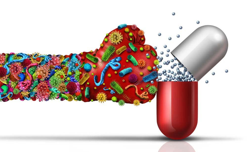 Fist hiting a medicine capsule for antibiotic resistance.