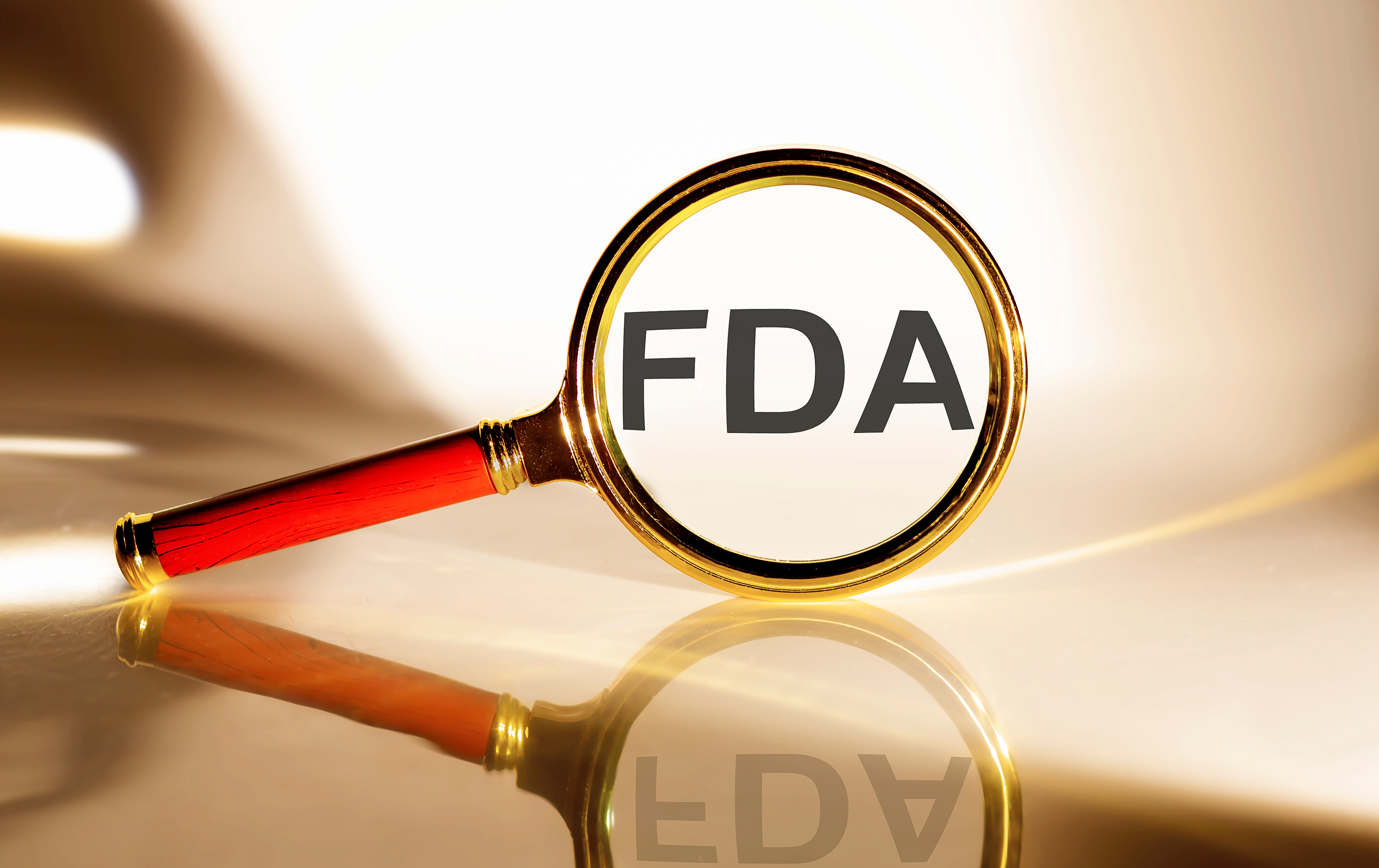 FDA in bold letters seen through a magnifying glass