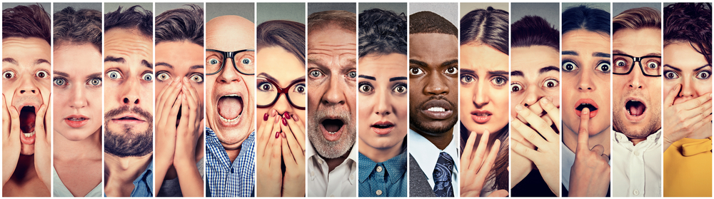 A multiethnic group of startled people in the backroom of supporting an audit.