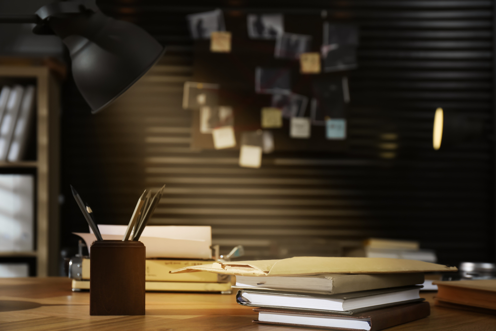 To be a good employee being brought into an audit room, you have to become a detective and understand how the evidence fits together. The image is an office interior with an evidence board on the wall.